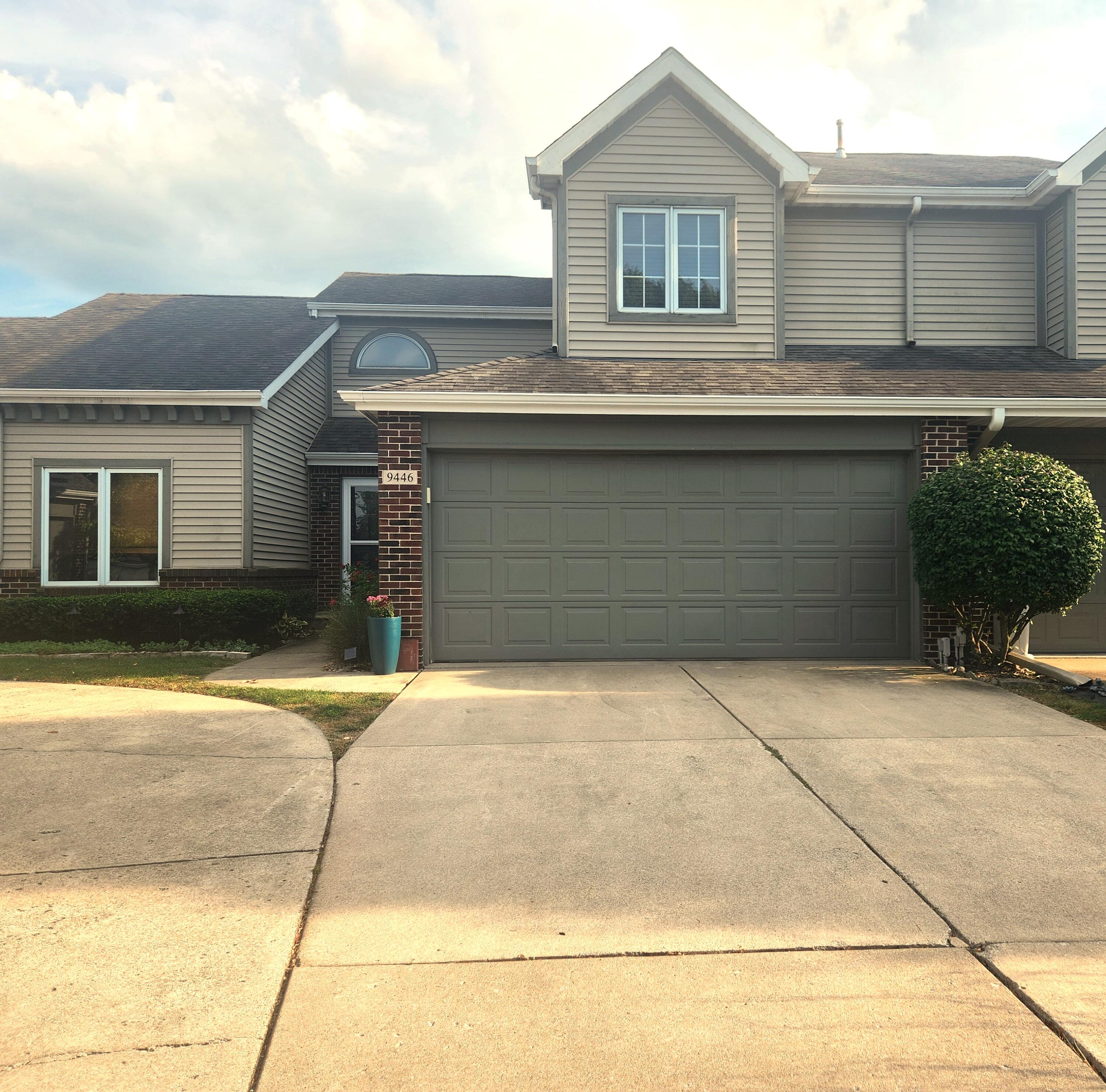 a front view of a house with garage