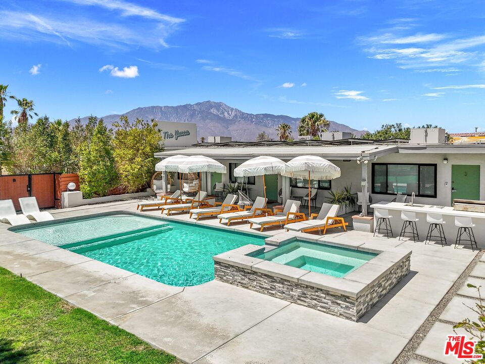 a view of a house with swimming pool and a yard