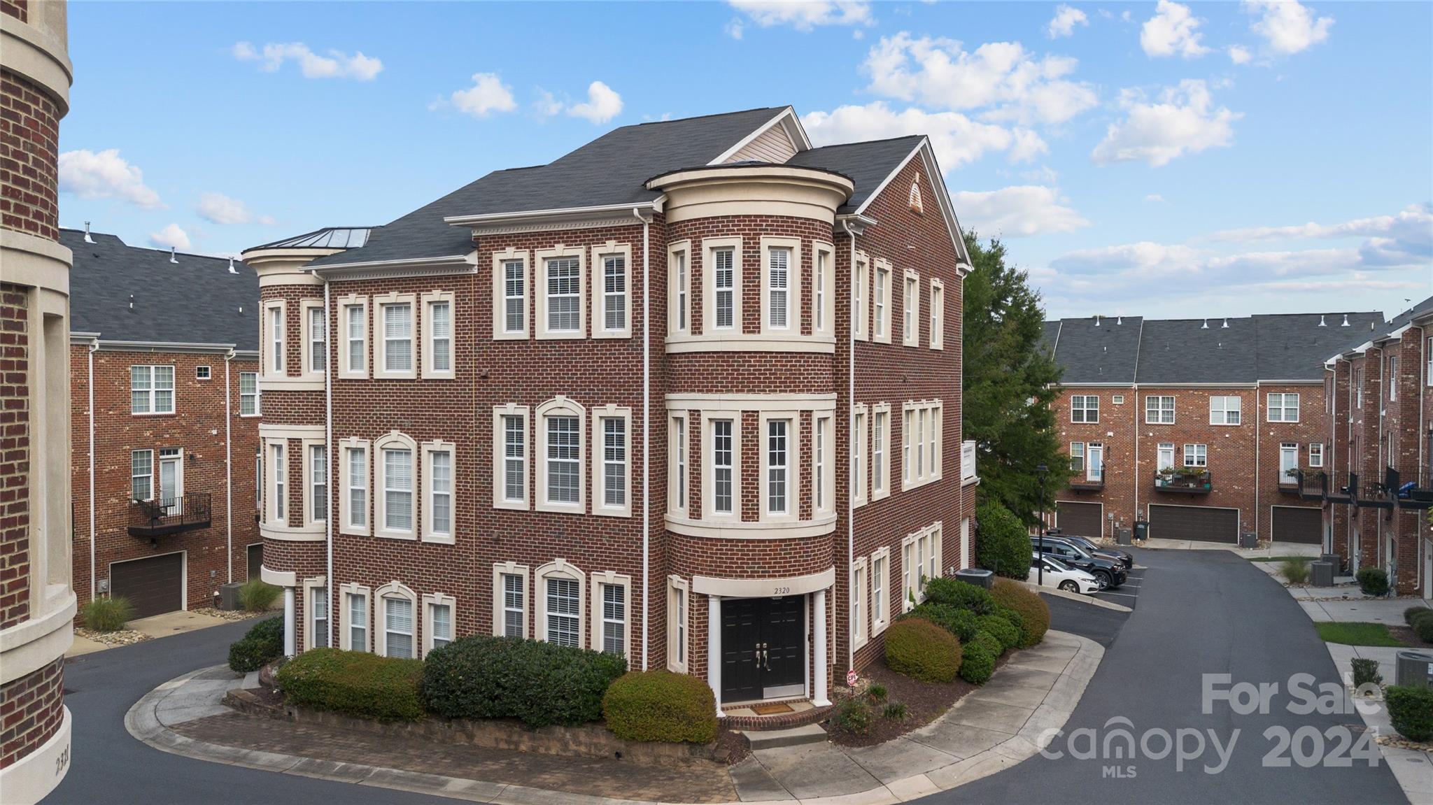 a front view of a residential apartment building with a yard