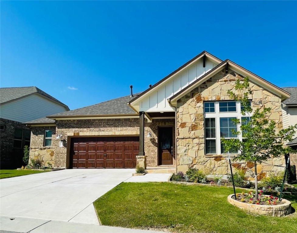 a front view of a house with a yard and garage