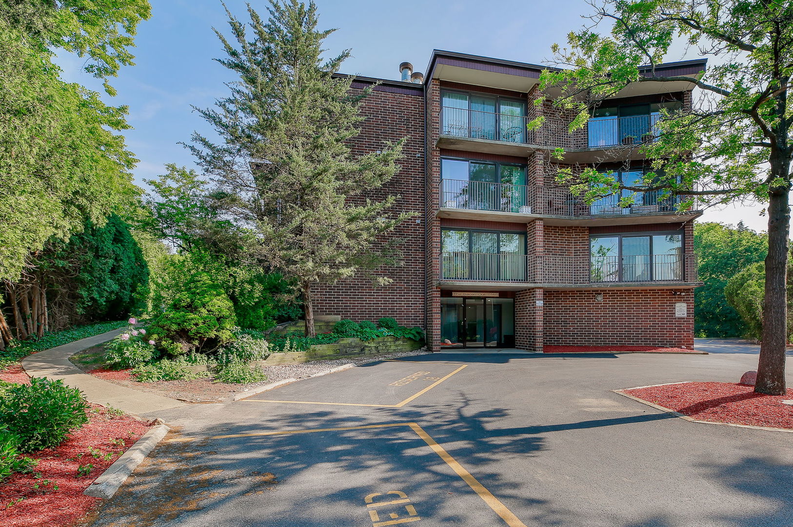 a front view of a residential apartment building with a yard