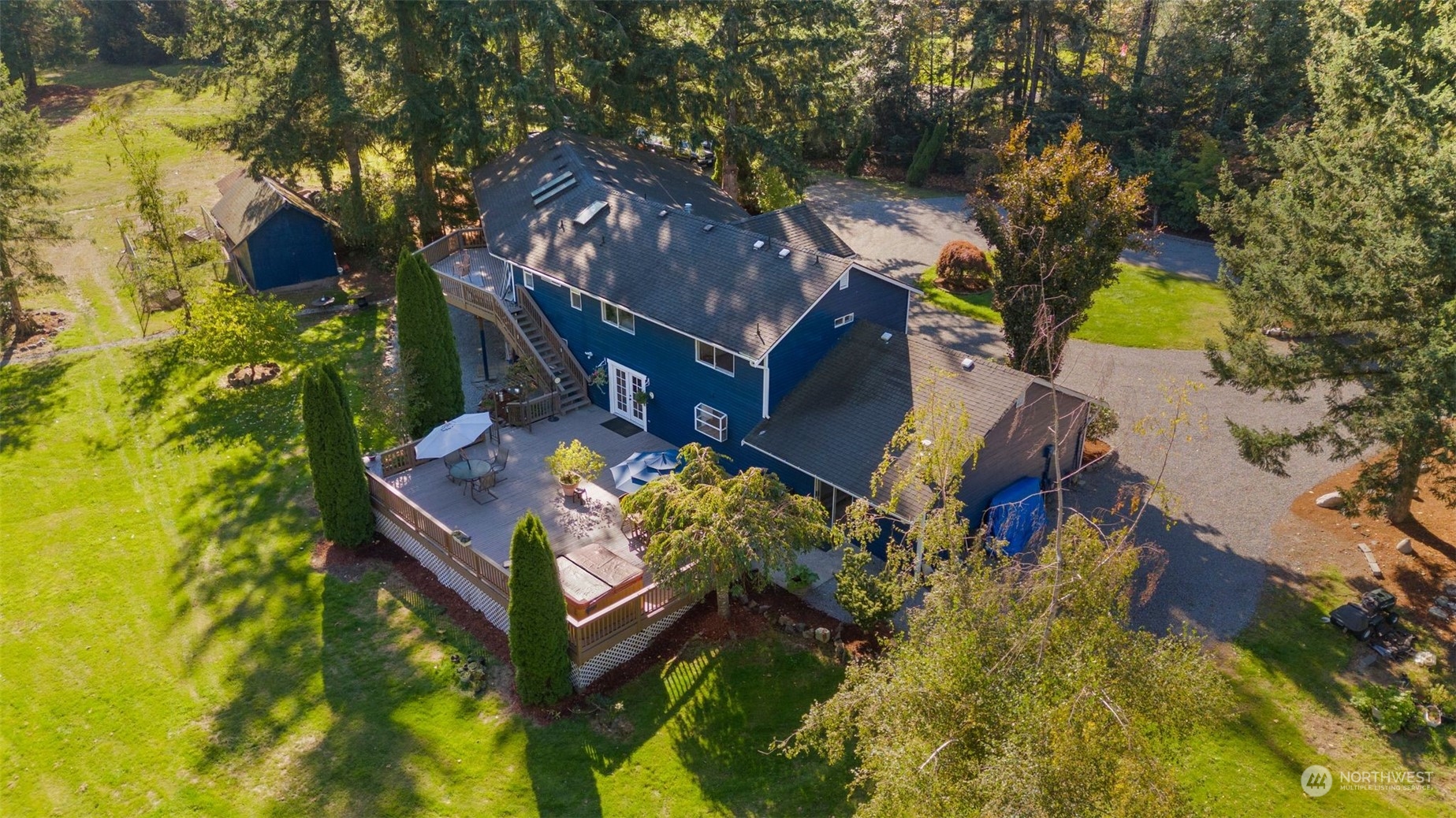 a view of a house with a big yard and large trees