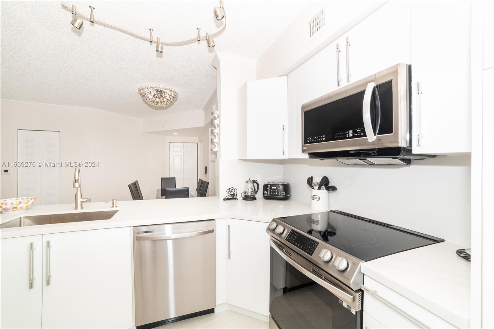 a kitchen with a sink a stove and microwave