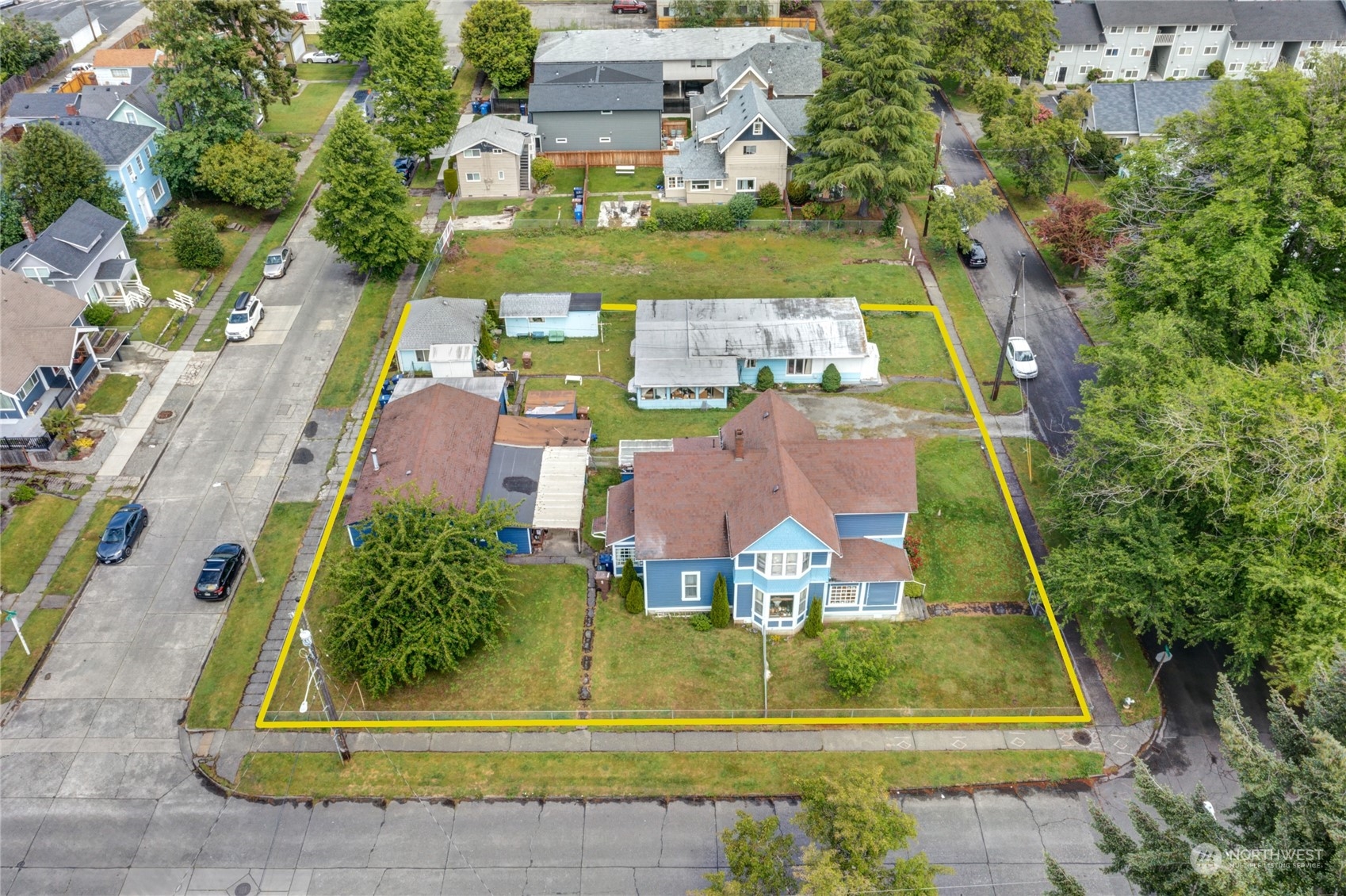 an aerial view of a residential apartment building with a yard