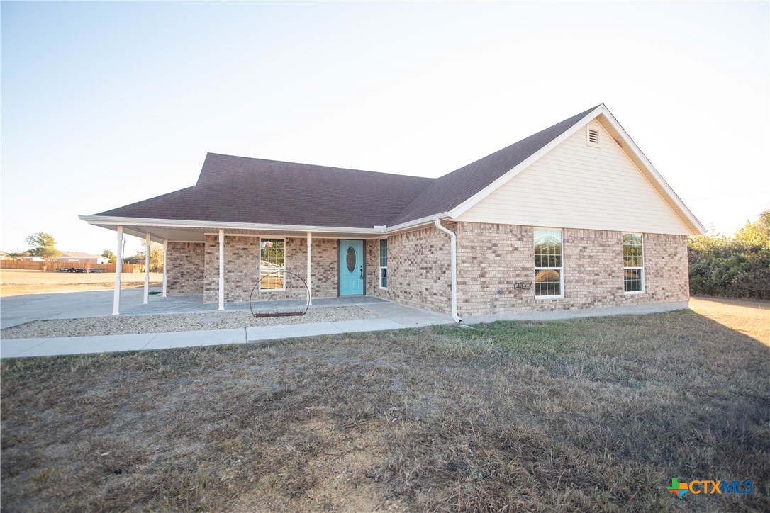 a view of house with yard and entertaining space