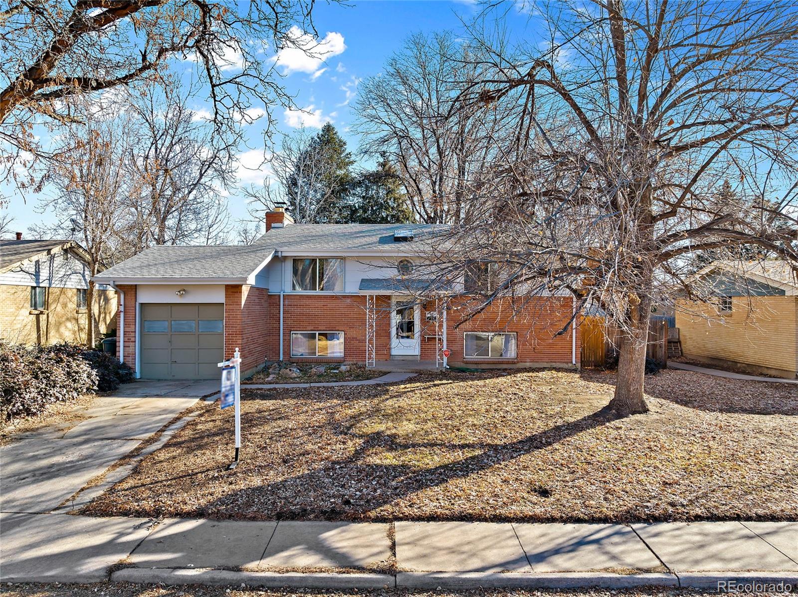 a front view of a house with trees