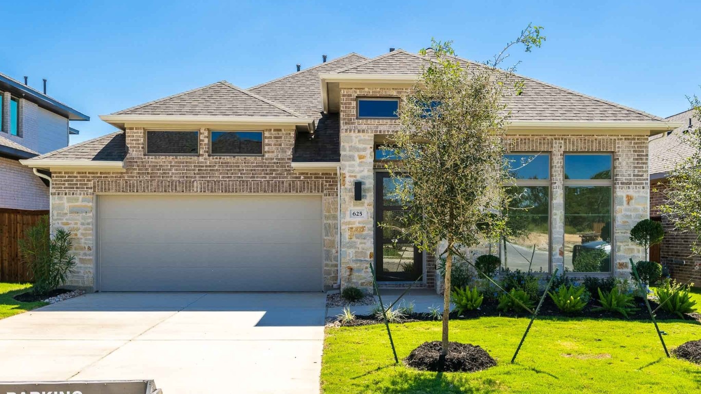 a front view of a house with a yard