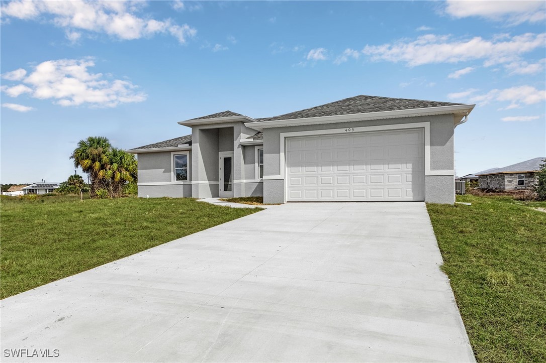 a front view of a house with a yard and garage