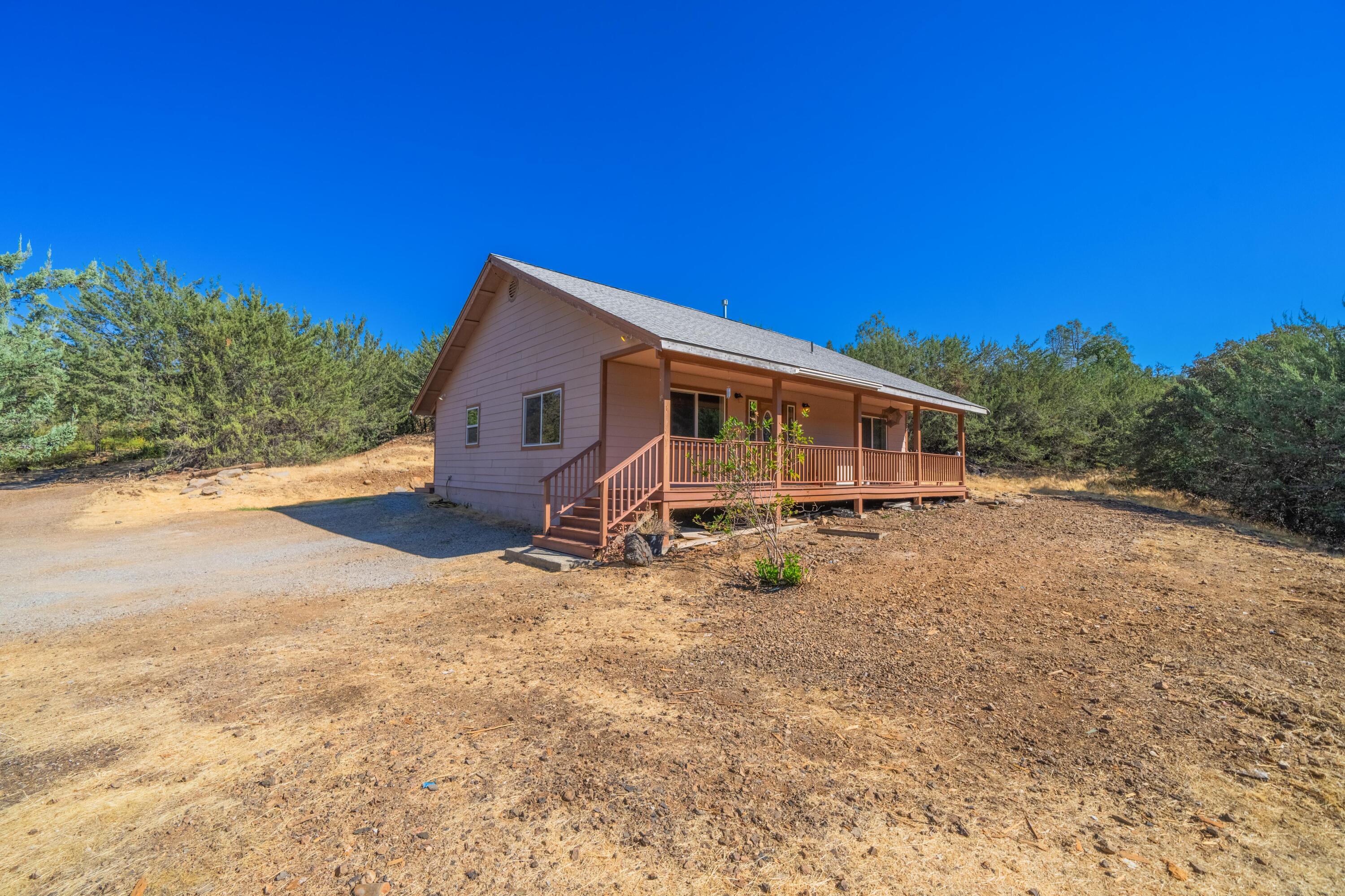 a view of a house with backyard and sitting area