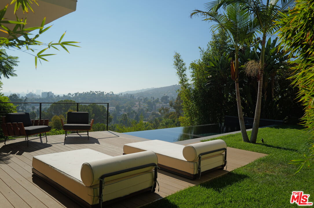 a view of a patio with couches and a fire pit