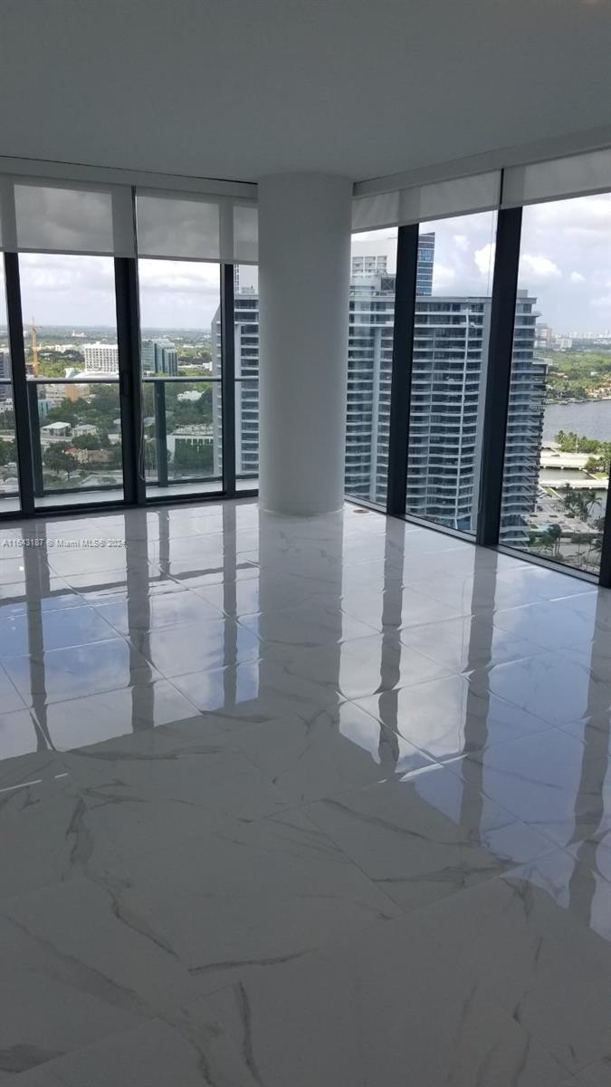 wooden floor in an empty room with large windows