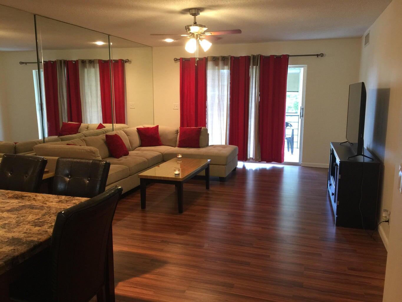 a living room with furniture window and wooden floor