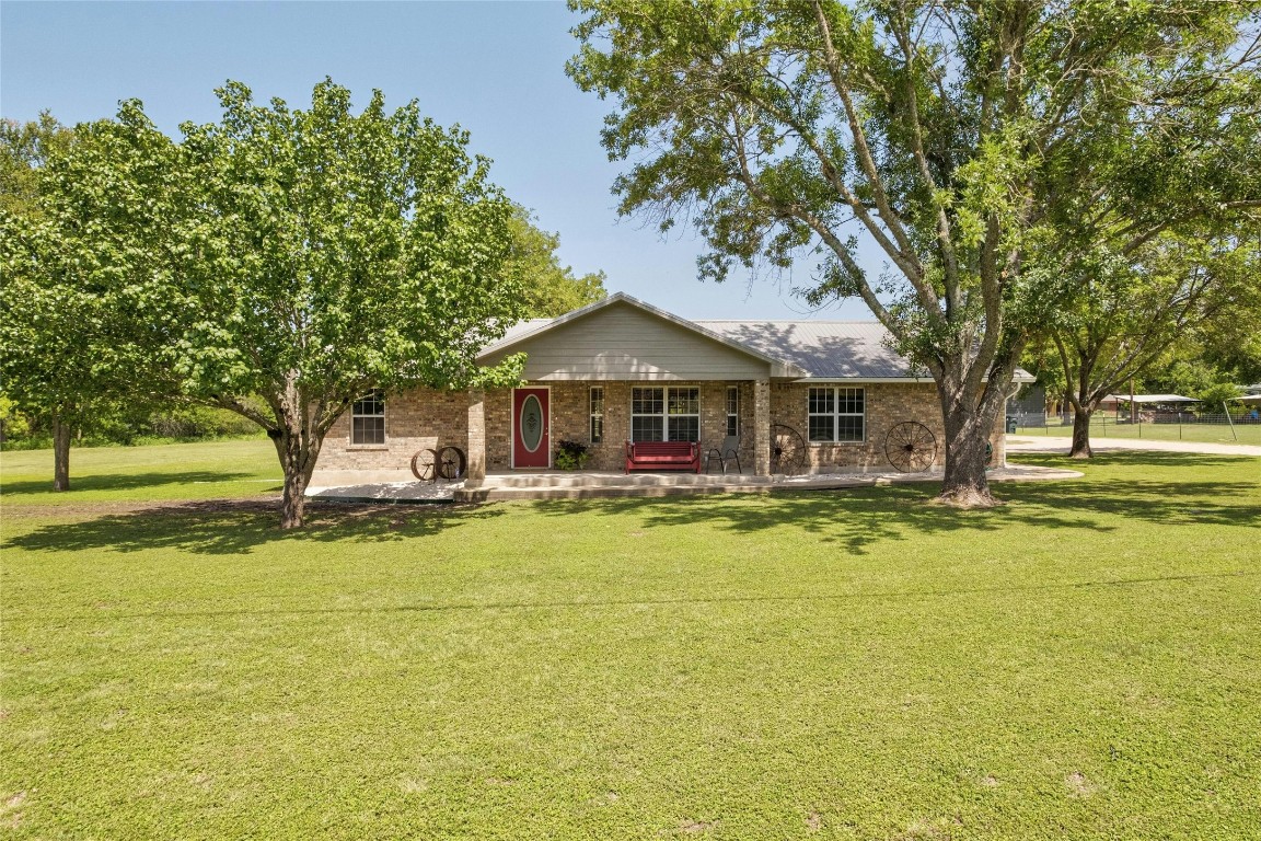 a front view of a house with swimming pool having outdoor seating