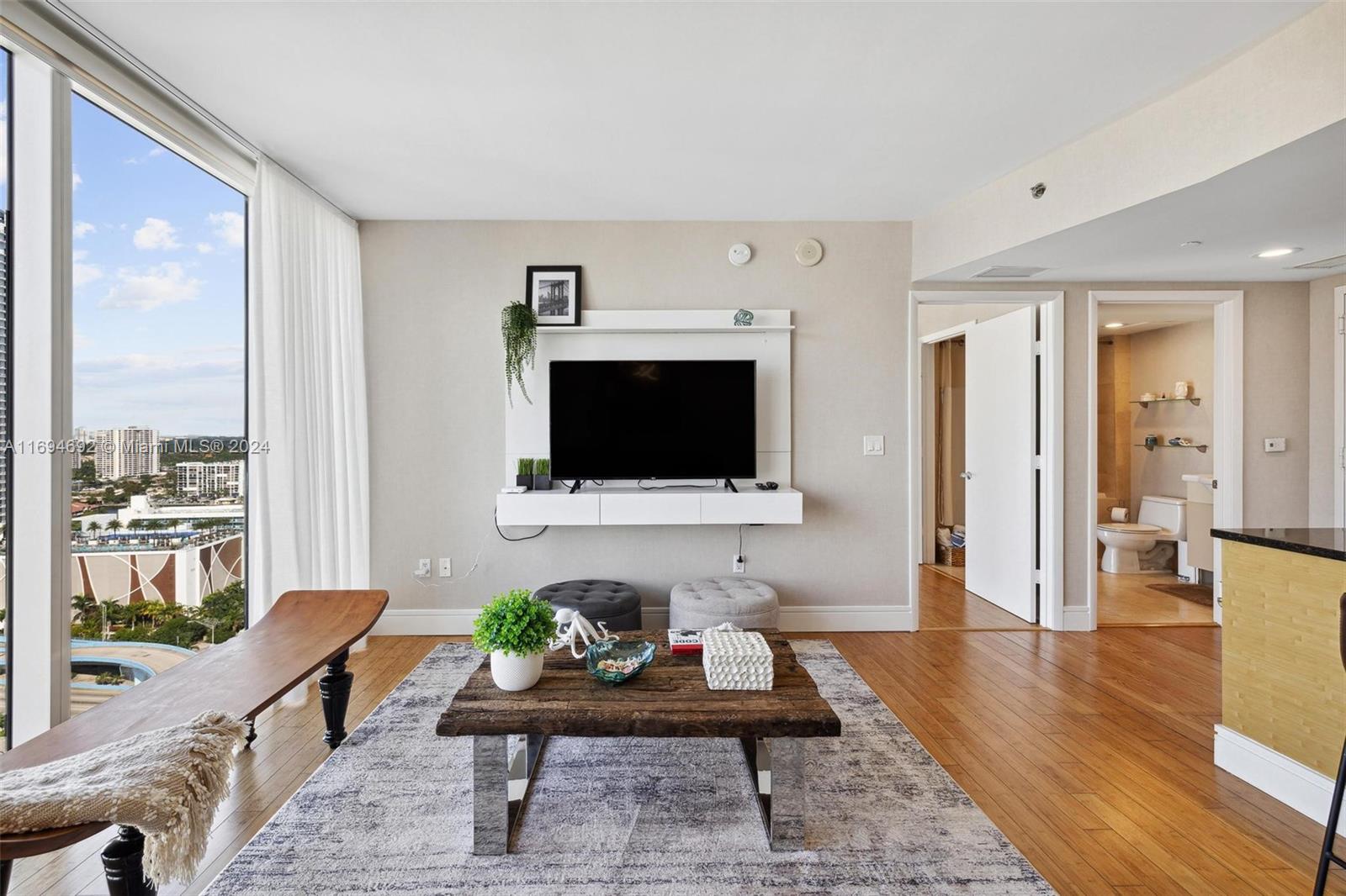 a living room with furniture and a flat screen tv