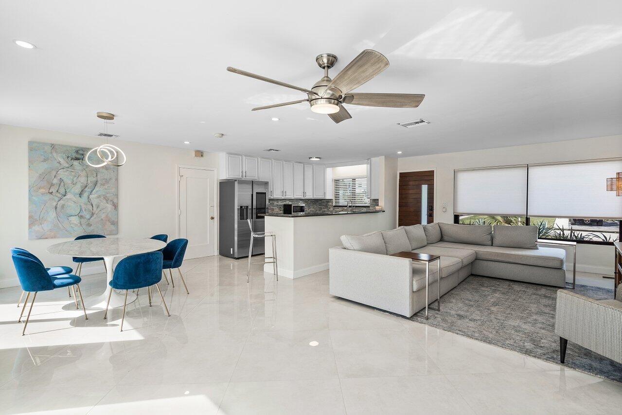 a living room with furniture and kitchen view