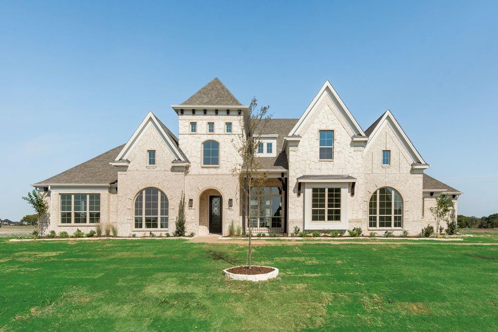 a view of a white house with a yard