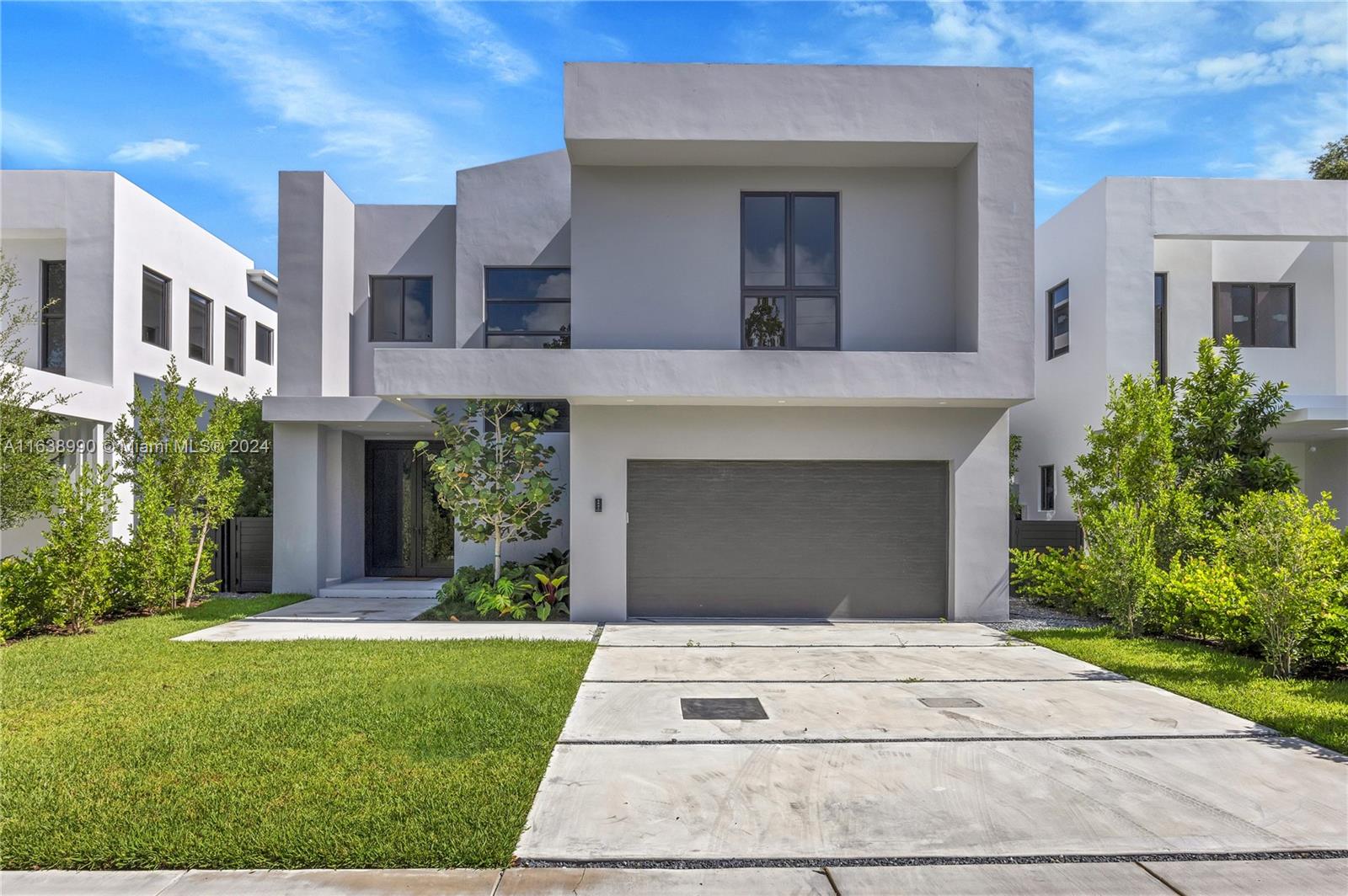 a front view of a house with a garden