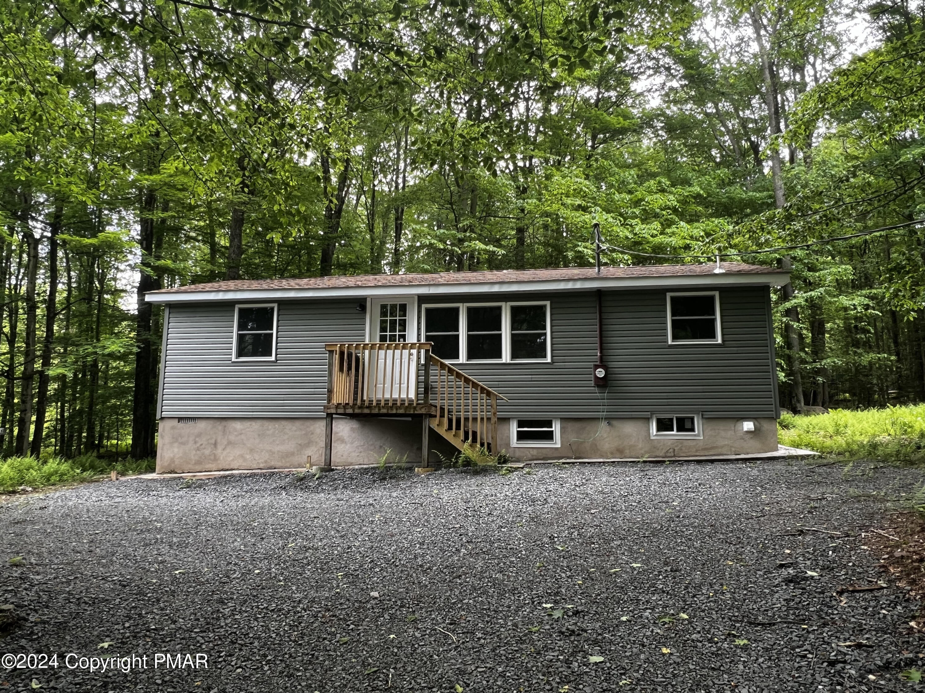 a view of house with backyard space and garden