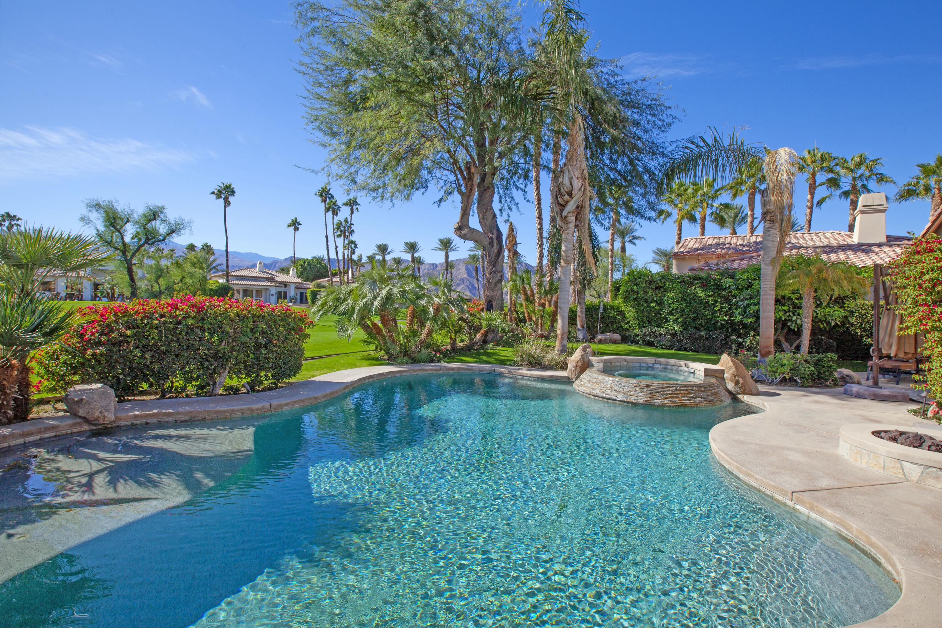 a swimming pool with outdoor seating and yard