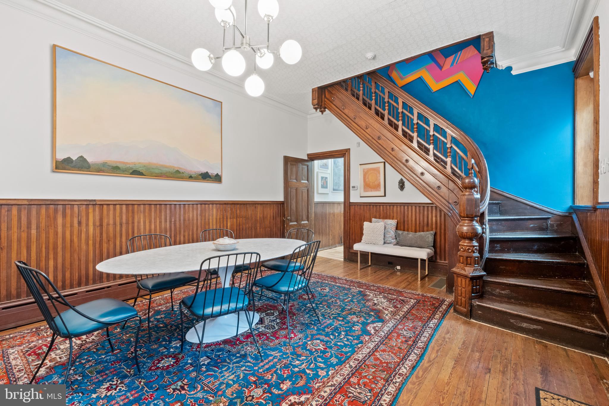 a view of a dining room with furniture wooden floor and a rug