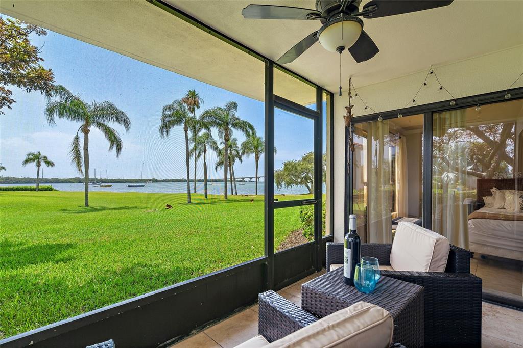 a living room with patio furniture and a garden