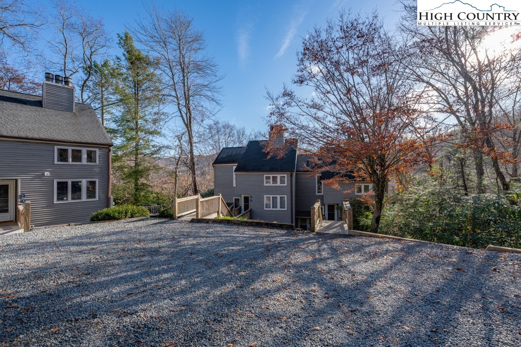 a view of a house with a large tree in front of it