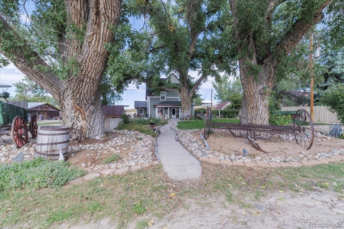 a view of a house with a tree in the yard