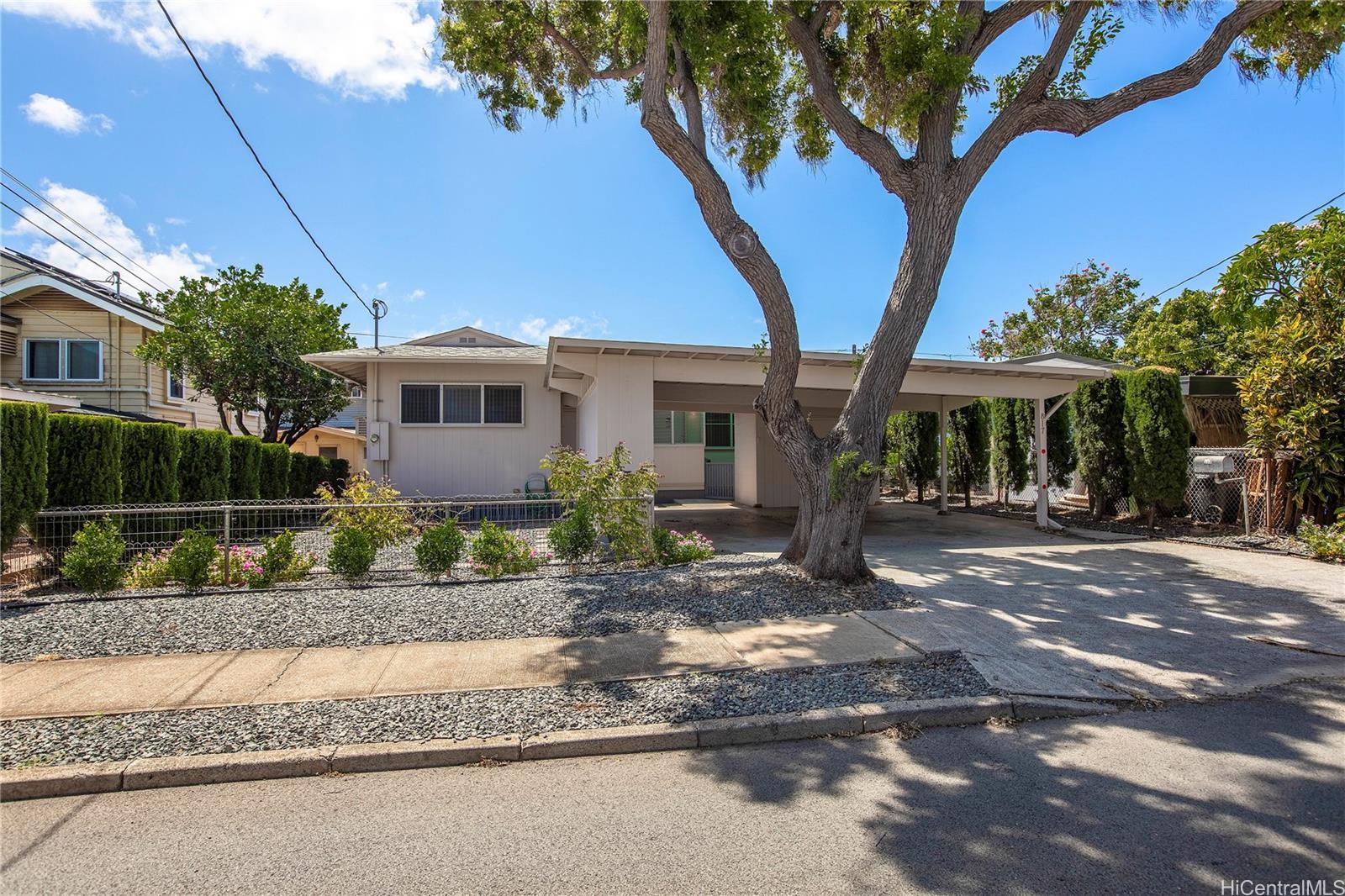 a view of a house with a tree in front