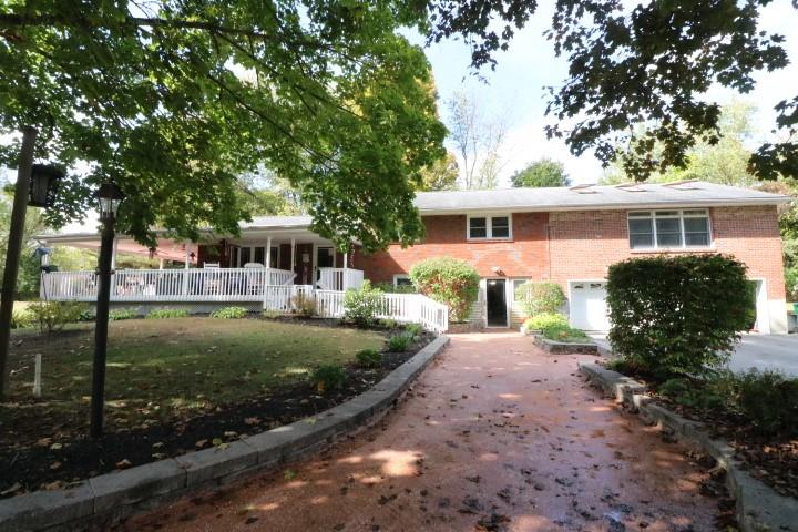 View of front of house with a front yard and a porch