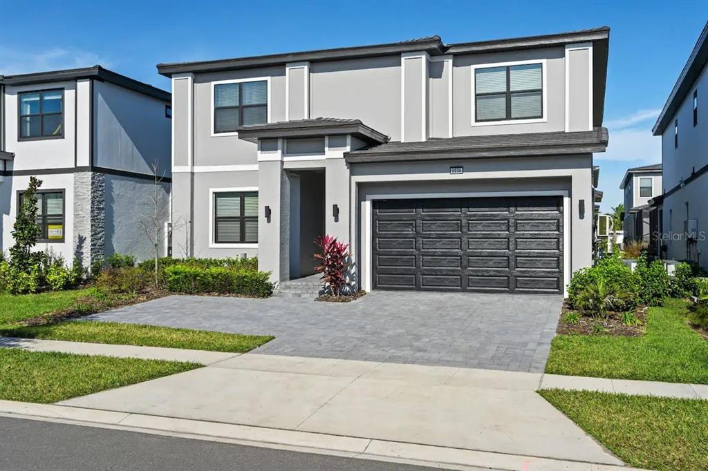 a front view of a house with a yard and garage