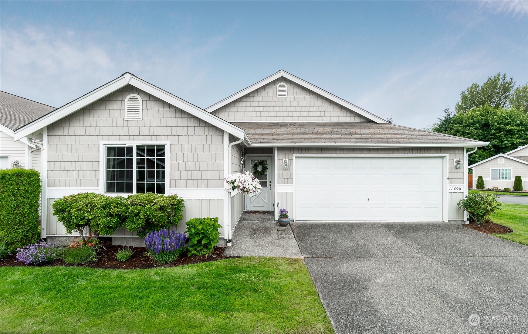 a front view of a house with a yard and garage