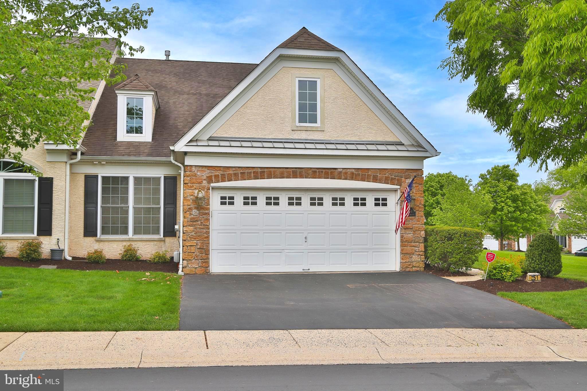 a front view of a house with a yard and a garage