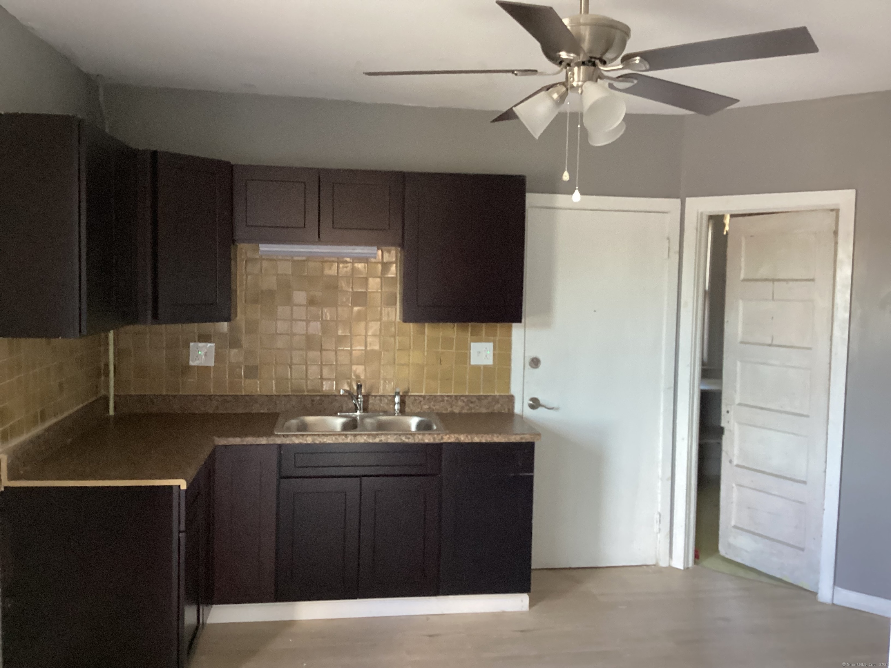 a kitchen with granite countertop a sink stainless steel appliances and cabinets