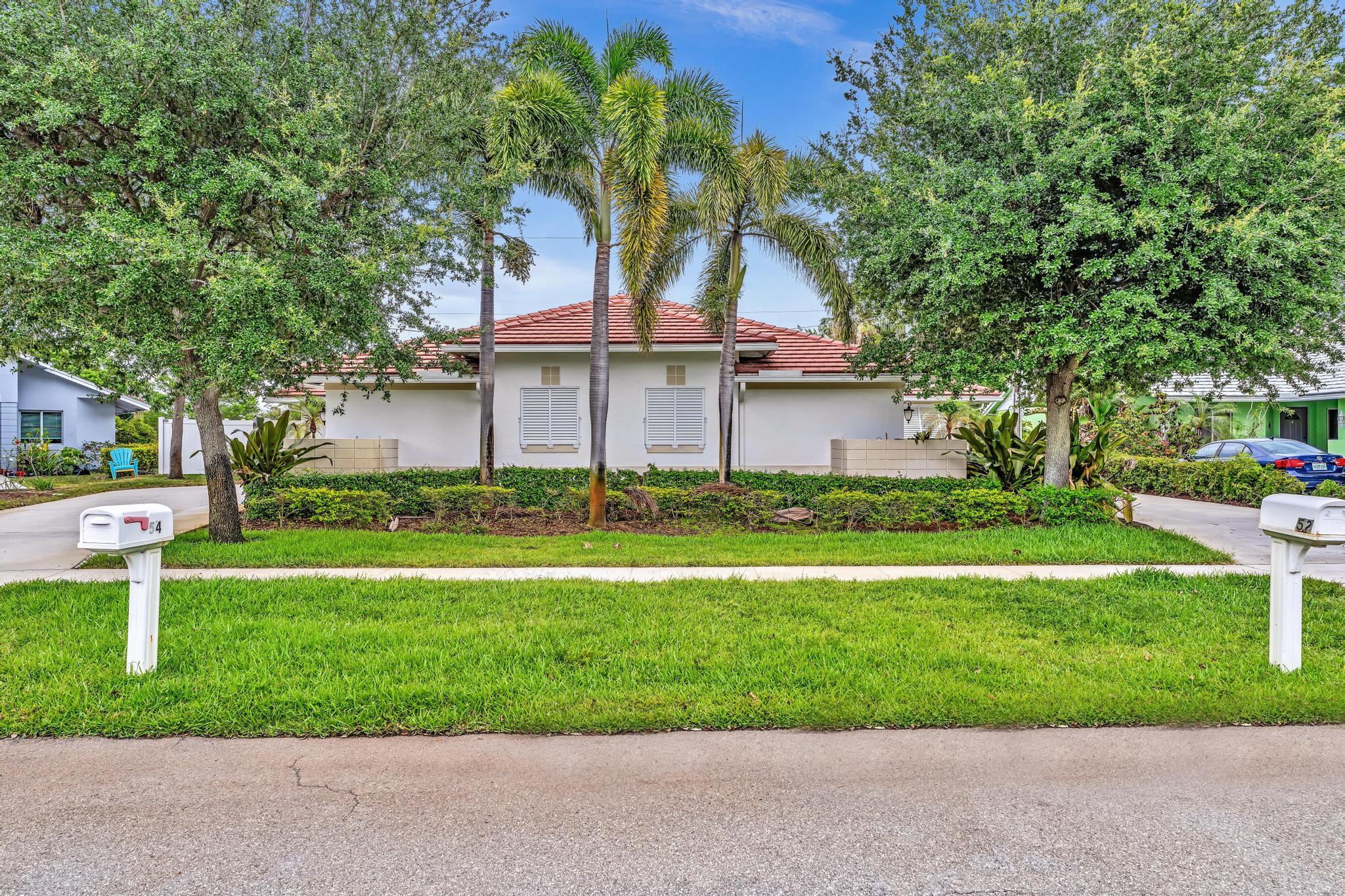 a front view of house with yard and green space