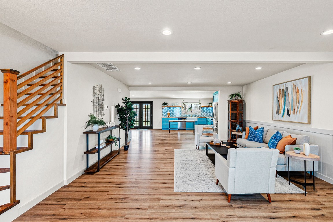 a living room with furniture and wooden floor