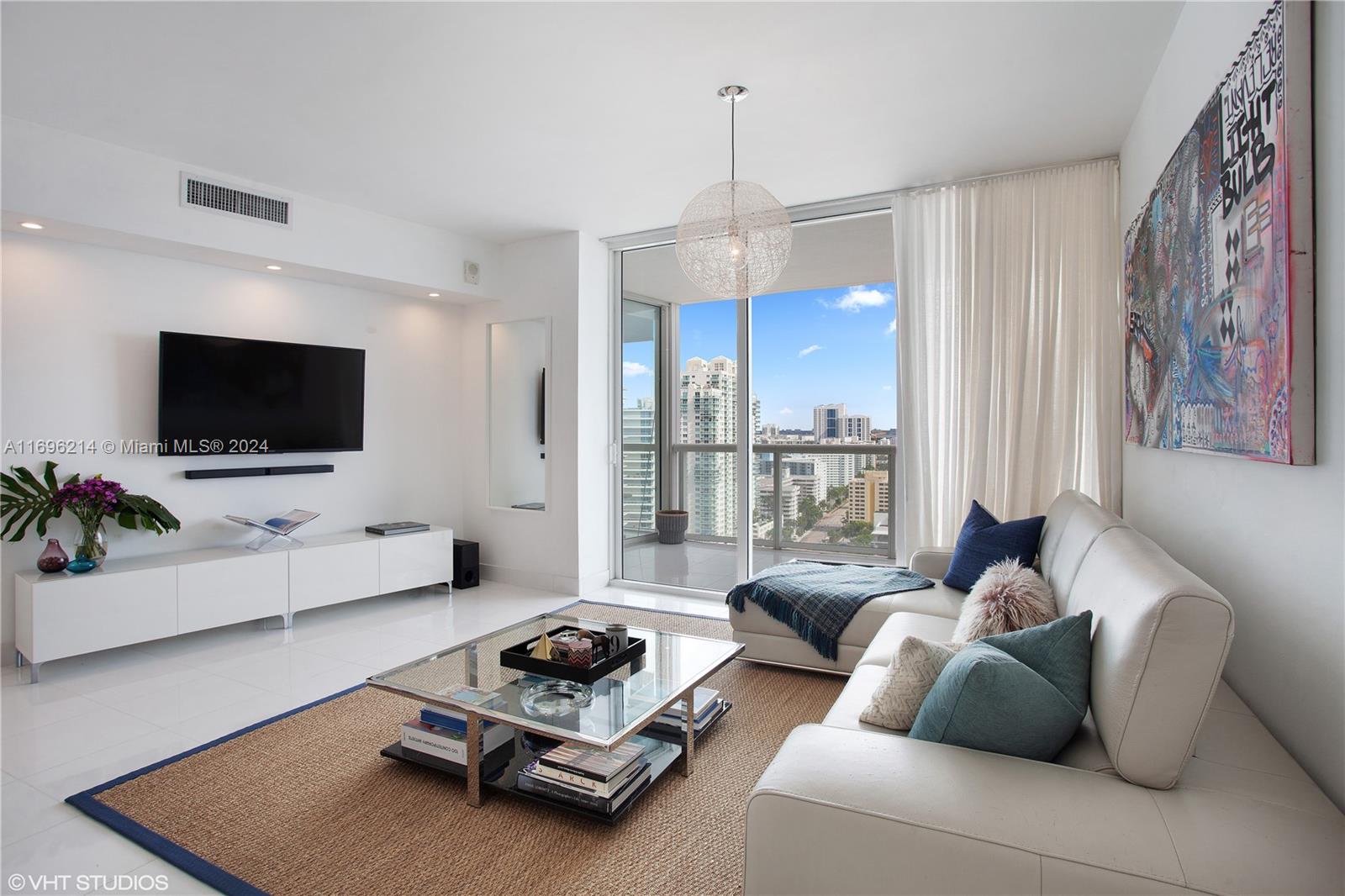 a living room with furniture and a flat screen tv