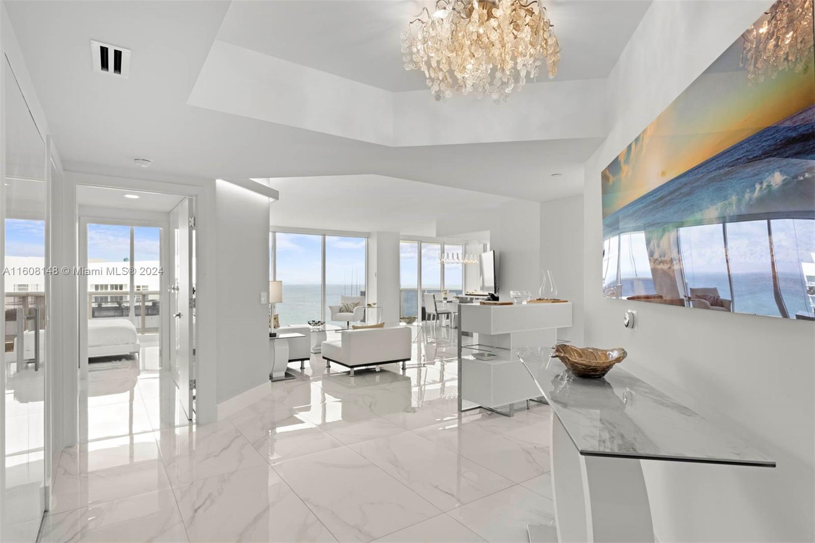 a living room with furniture and a chandelier