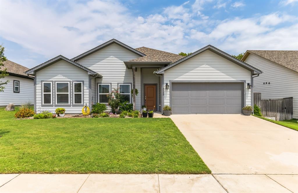 a front view of house with yard and green space