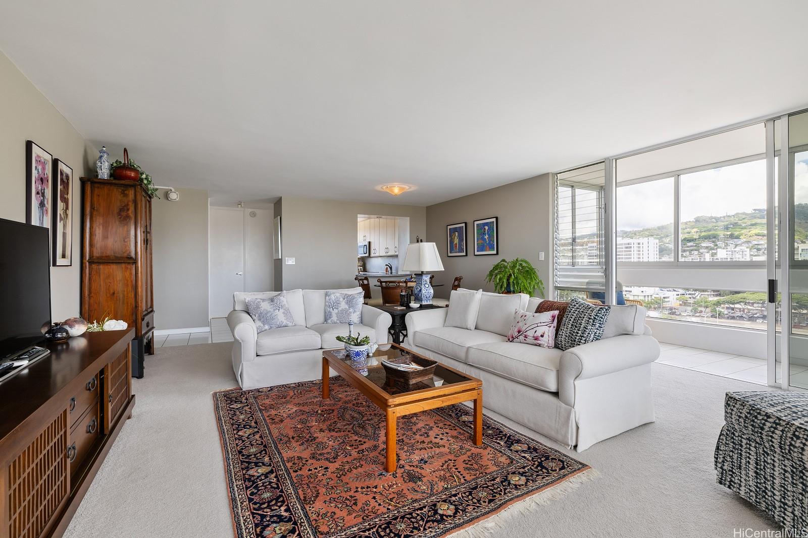 a living room with furniture large window and a flat screen tv