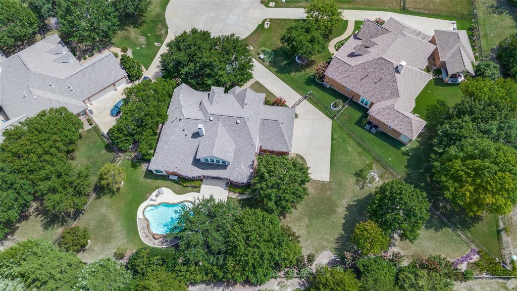 an aerial view of a house with garden space and street view