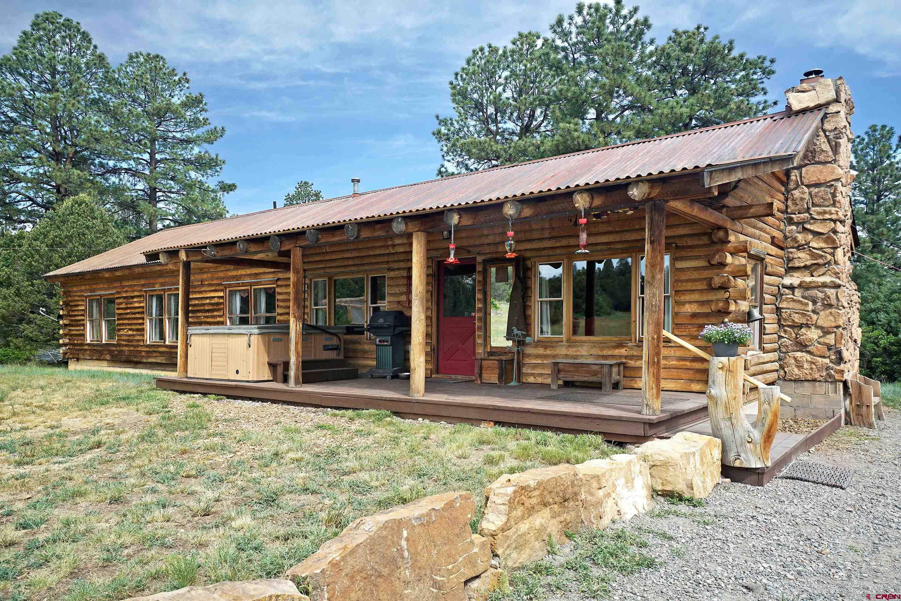 a view of a house with backyard porch and sitting area