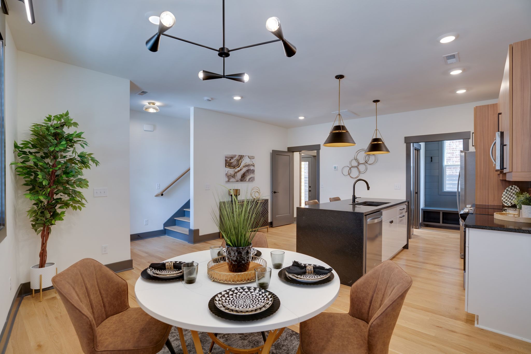 a view of a dining room with furniture a chandelier and wooden floor