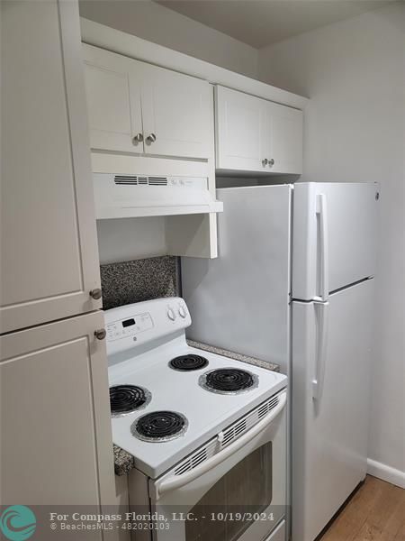 a kitchen with a stove and a refrigerator