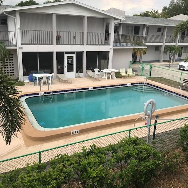 a view of a swimming pool with outdoor seating