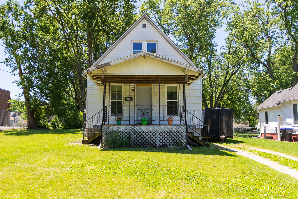 a front view of a house with yard and swimming pool