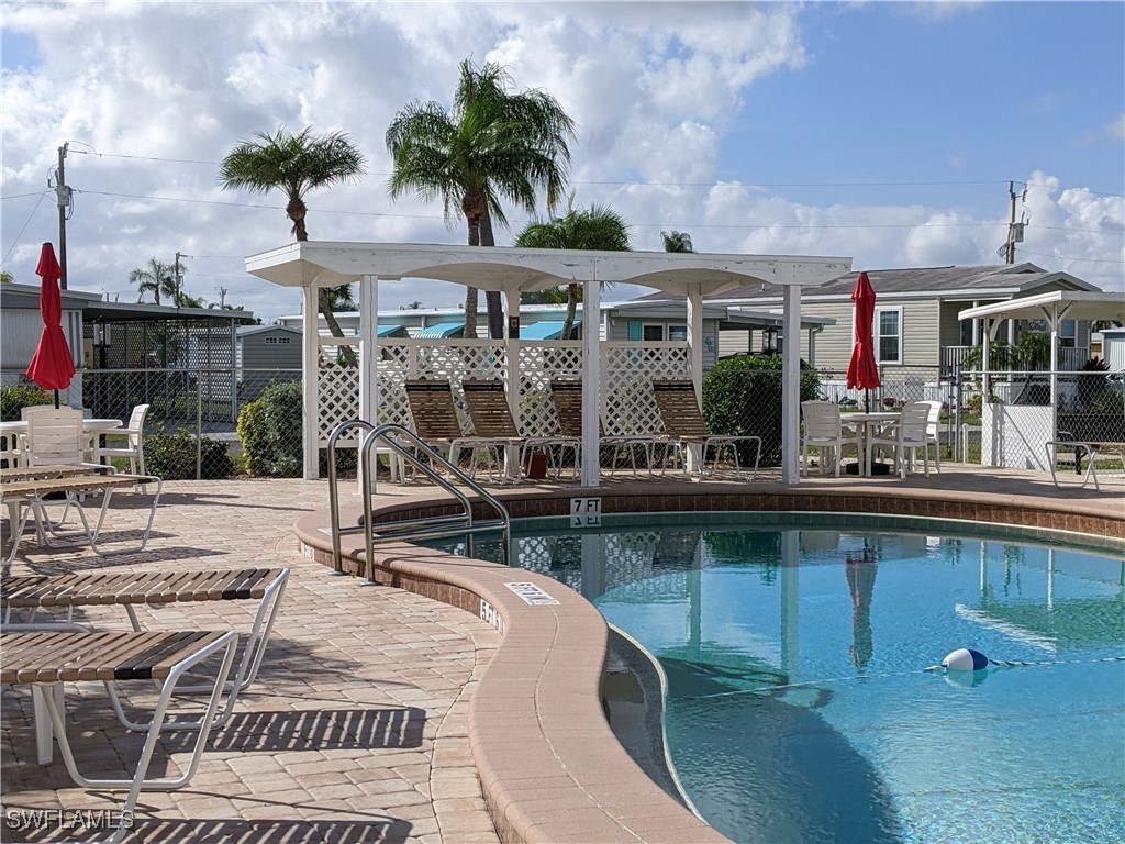 a view of a swimming pool with outdoor seating space