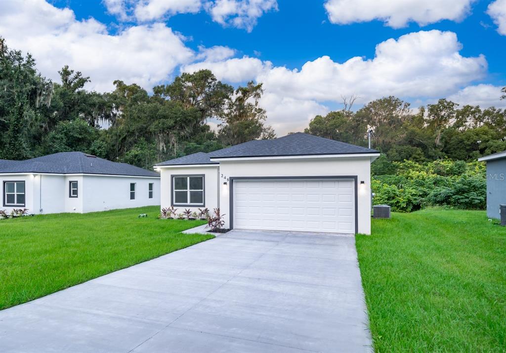 a front view of house with yard and green space