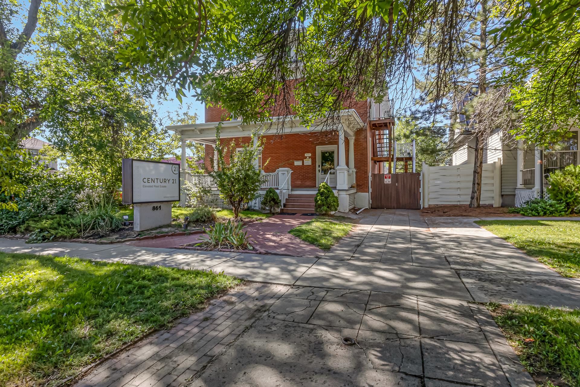 a view of a house with a yard and tree s