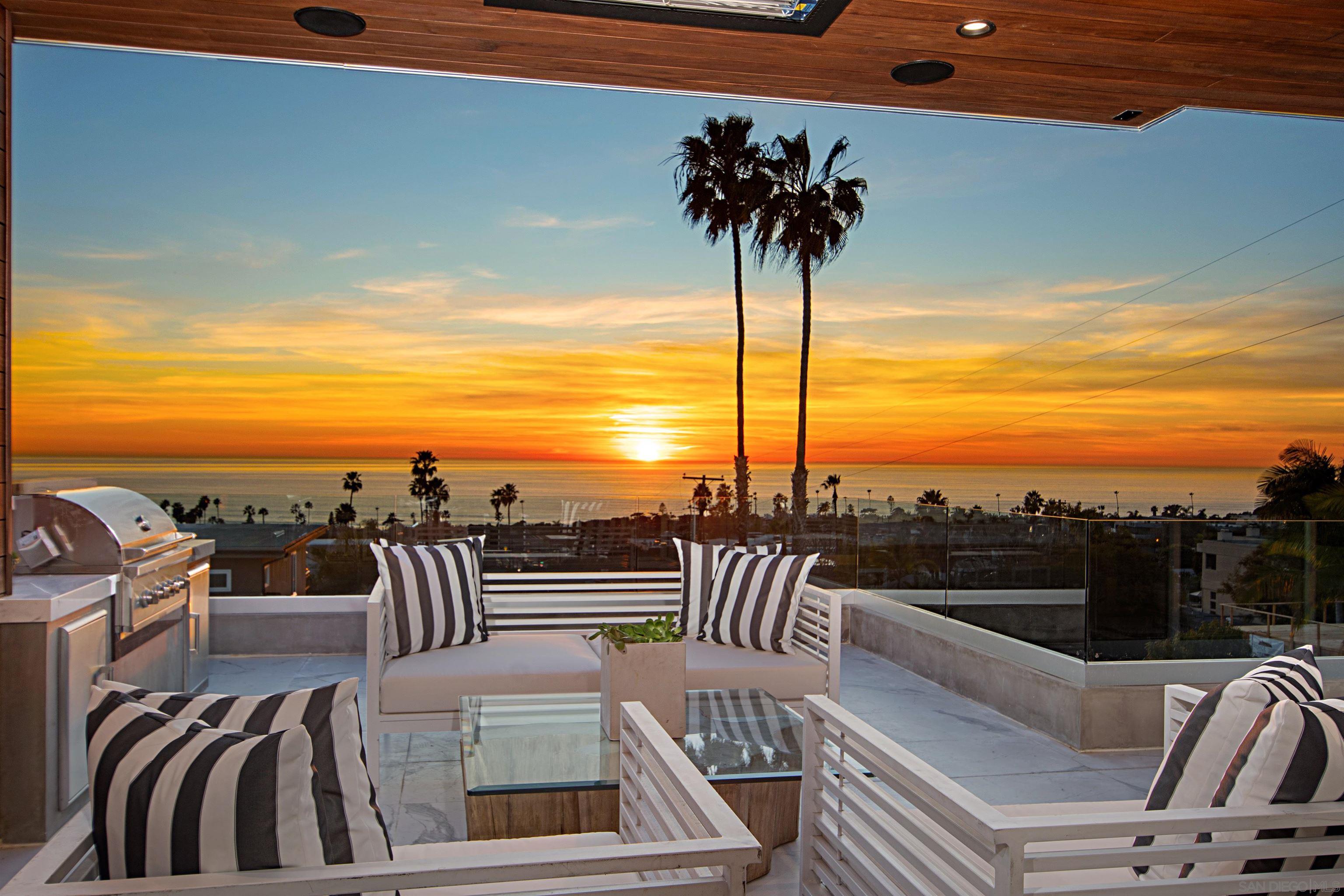 a view of a balcony with furniture and ocean view