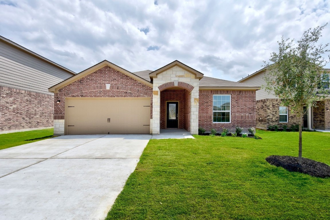 a front view of a house with a yard and garage